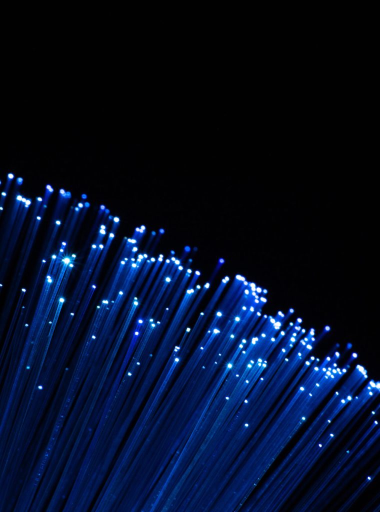 perfectly focused arc shaped blue fiber optic lights on black background